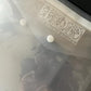 A close up image of Iron Orchid Designs semi-transparent Stamp Envelopes on a dark surface showing the popper fastening
