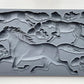 Iron Orchid designs Horse and Hound grey mould laying on a wooden surface