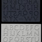 Iron Orchid Designs Victoria typography grey Mould above white clay castings of the mould