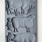 Iron Orchid Designs Village Market grey Mould with cow, sheep and pig laying on a wooden surface